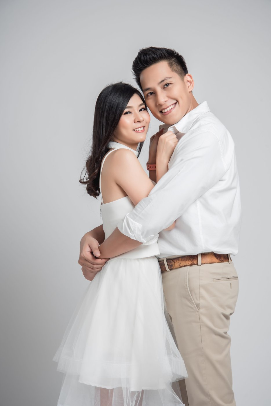 couple-embracing-while-standing-against-white-background (2).jpg